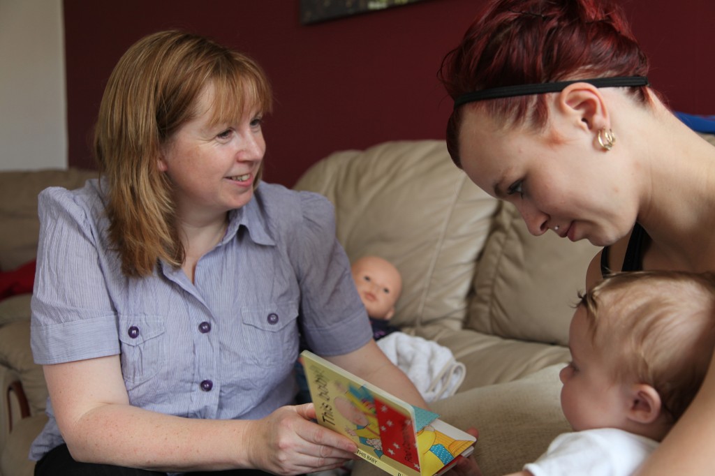 Family nurse talking to mother with child