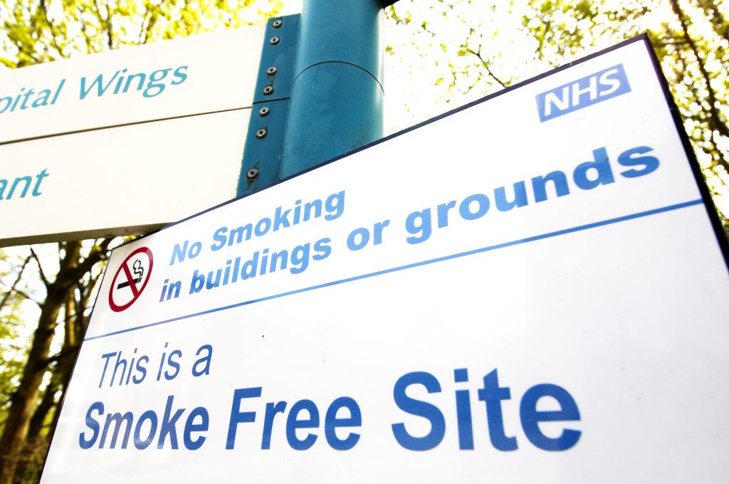 Unique ID: FRAM510 Caption: A sign indicating the hospital building and grounds are smoke-free. No smoking. Smoke Free Site. Restrictions: NHS Photo Library - for use in NHS, local authority Social Care services and Department of Health material only Copyright: ©Crown Copyright