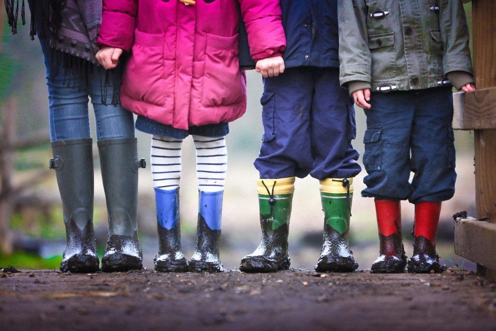 Group of small children standing together in winter clothes
